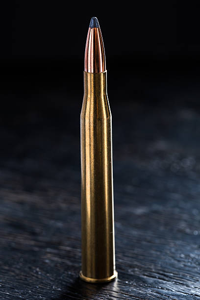 istock Large-caliber cartridge on a dark background 500367222