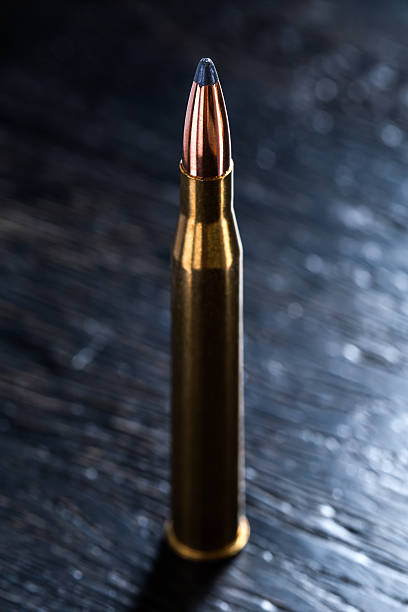 istock Large-caliber cartridge on a dark background 500367462