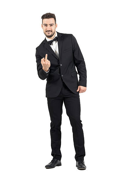 istock Rude man in tuxedo with bowtie showing middle finger gesture 500367552