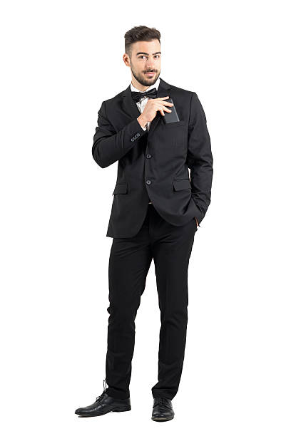 istock Smiling confident man in suit putting cellphone in suit pocket 500367596