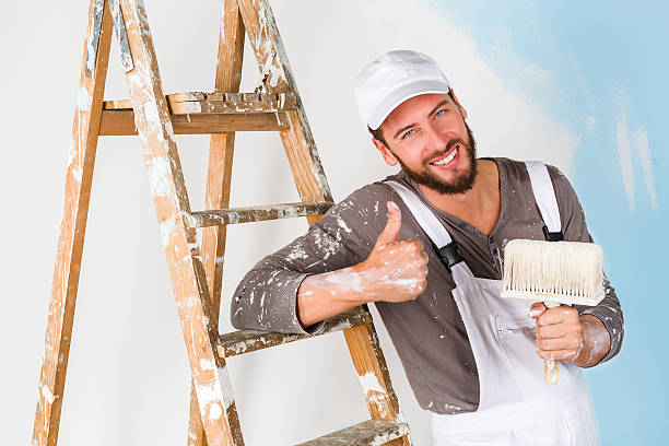 istock painter in white dungarees with thumbs up gesture 500367692