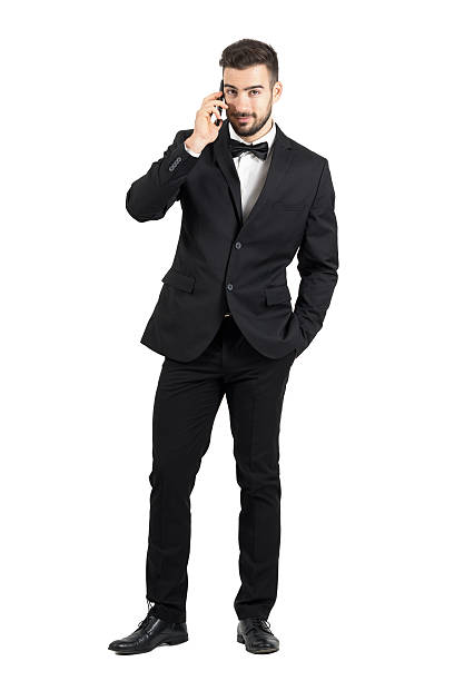 istock Smiling handsome man in formal wear talking on the smartphone 500367766