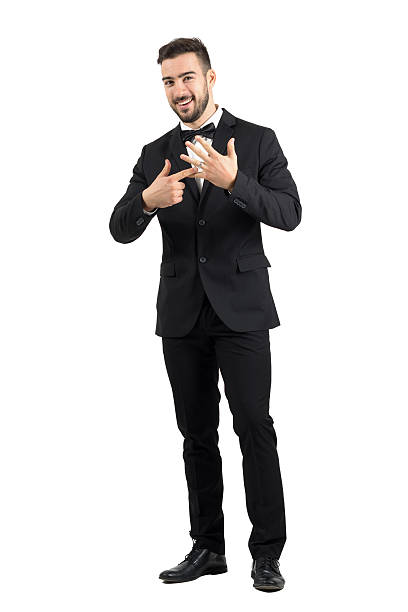 Happy smiling just married groom pointing to wedding ring