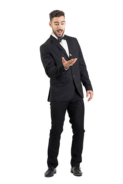 Playful excited young groom tossing wedding ring.