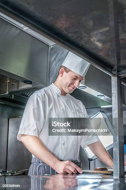 Chef Considering A Prescription Young Chef Preparing A Deliciou Stock Photo - Download Image Now