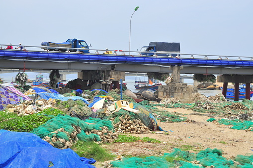 Nha Trang, Vietnam - July 11, 2015: Slum under the bridge in Nha Trang city