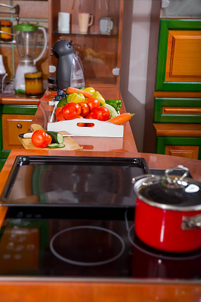 istock Pot and vegetables in modern kitchen with induction stove 500370180