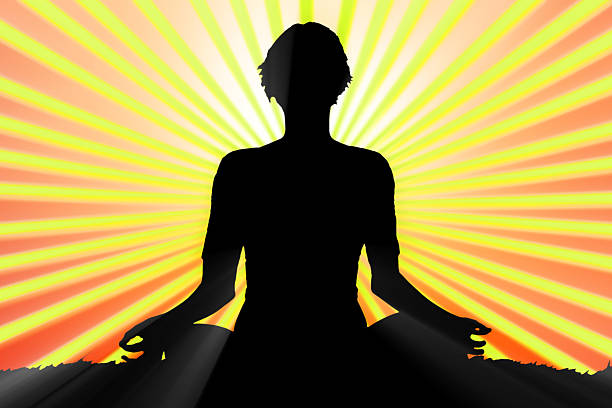 istock meditating woman silhouette 500373245