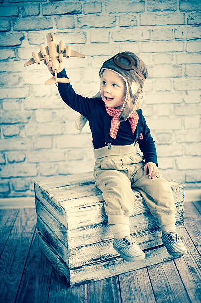 istock Happy kid playing with toy airplane 500373413