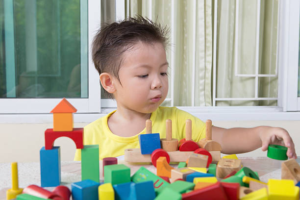 istock three-year child plays with toy blocks 500374163