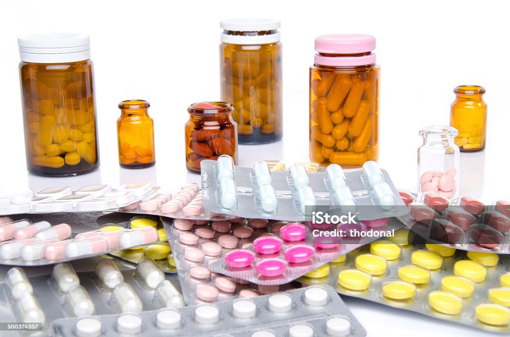 Pills, tablets and capsules in blister packs and bottles Pills, tablets and capsules in blister packs and bottles, isolated on white Acetylsalicylic Acid Stock Photo