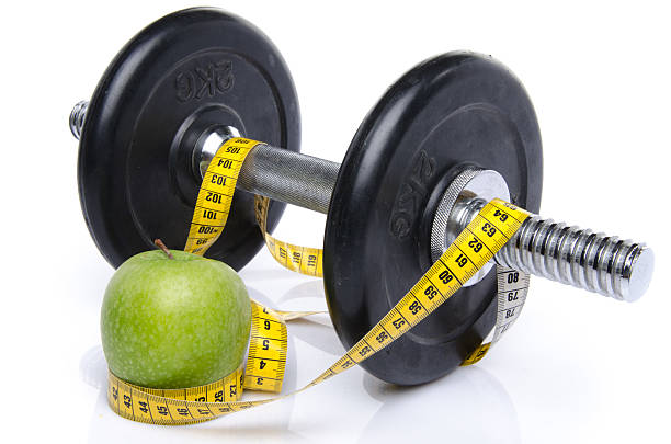 istock Dumbell and an apple with a tape measure 500374377