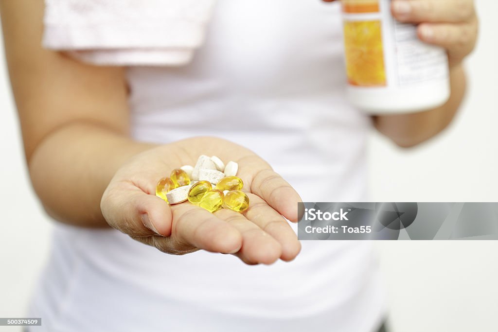 sport and diet concept - woman hand with medication sport and diet concept - woman hand with vitamins and medication Number 6 Stock Photo