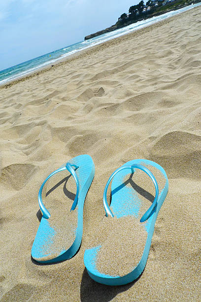 istock Flip flops and towel on the beach 500375821