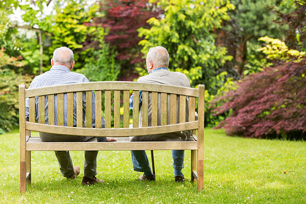 istock Two senior men sitting on bench in the park 500376637