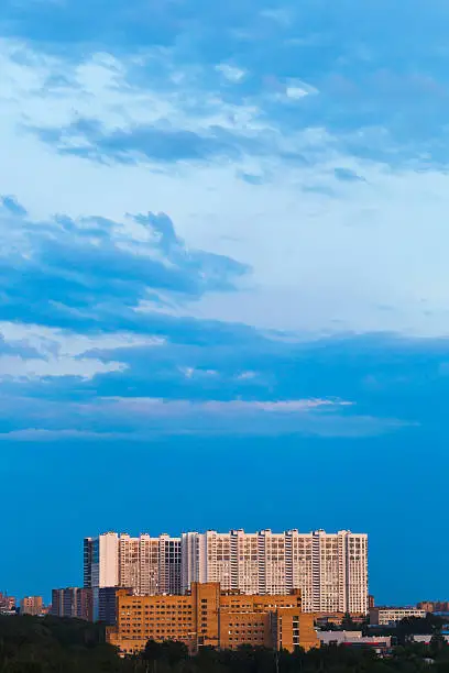 blue gloaming sky over urban house in summer evening