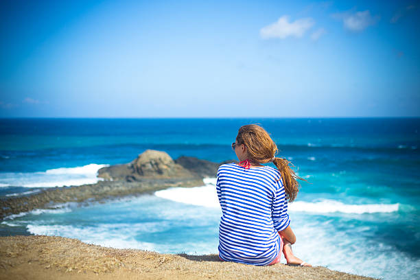 istock girl sitting on a mountain 500376931