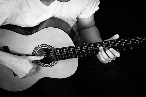 istock Asian Musician plays Acoustic Guitar 500377089