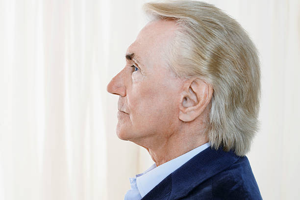 istock Side View Of Senior Man By Curtain 500377161