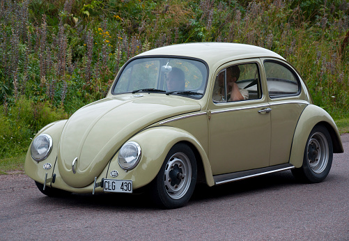 An old classic car sitting in the street