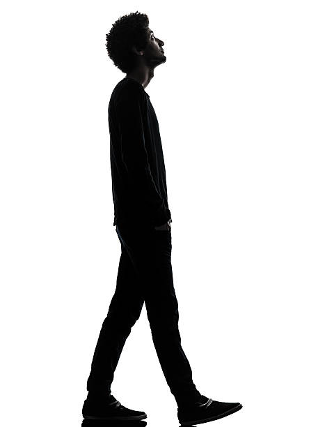 istock handsome african young man walking looking up silhouette 500388851