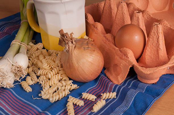 istock onion; sheat; blue; mug; cooking; ingreedients; kitchen; table; pasta, eggs 500389249