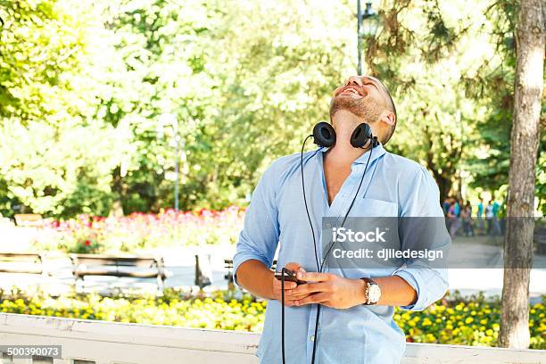 Handsome Guy In The Light Blue Shirt Posing With Headphones Stock Photo - Download Image Now