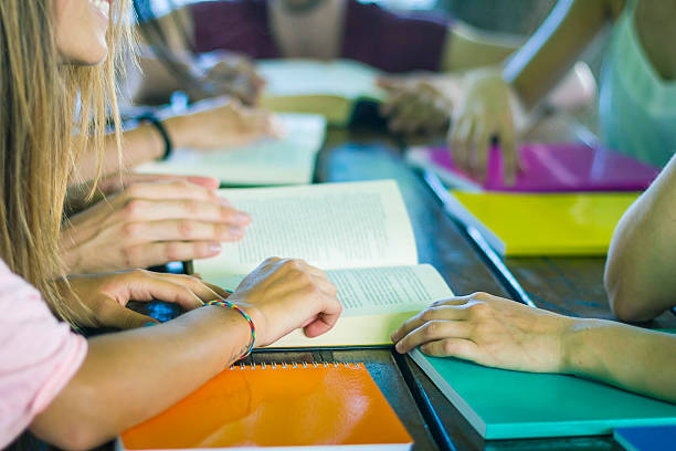 istock Group of students at work with books on table 500390703