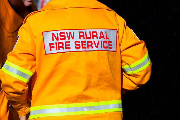 istock Rear view of fireman in yellow protective jacket, copy spaec 500391615