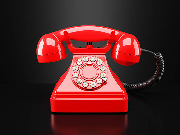 istock Red vintage phone on black background. Hotline 500391726