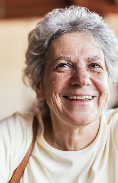 istock Mature Woman Looking Up With Genuine Smile 500392189