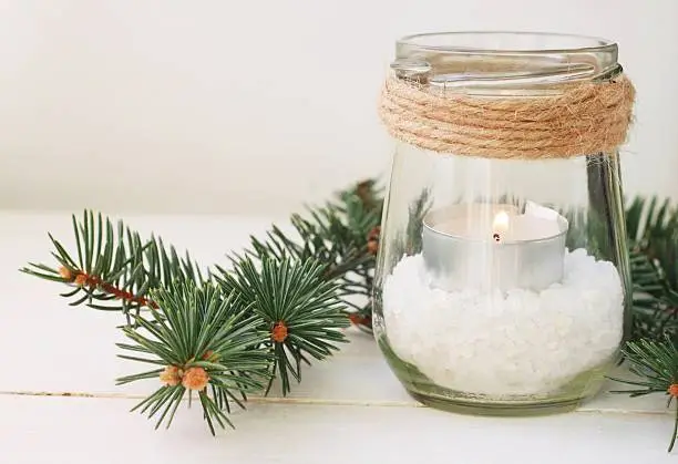 Winter style home decor - tea light candle in jar with sea salt, pine boughs, rustic twine.