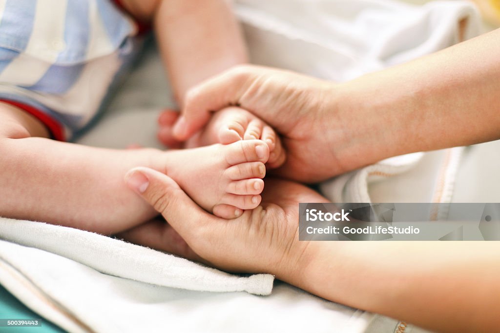 Baby feet Feet of a baby held by his mother 0-11 Months Stock Photo