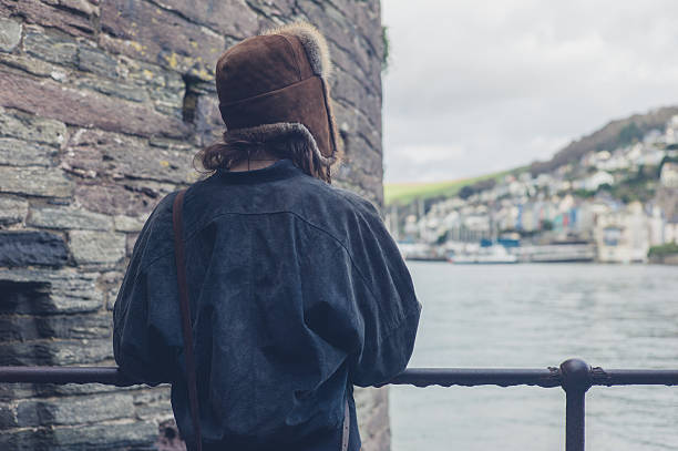 istock Woman looking at water in village 500396548