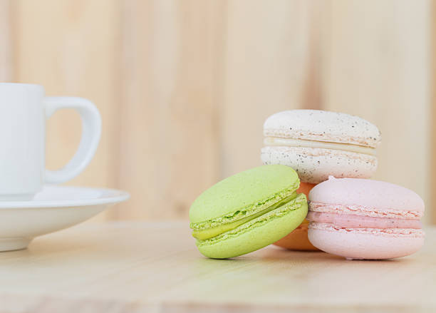 istock Sweet Macaroons with cup on wooden background. 500402346