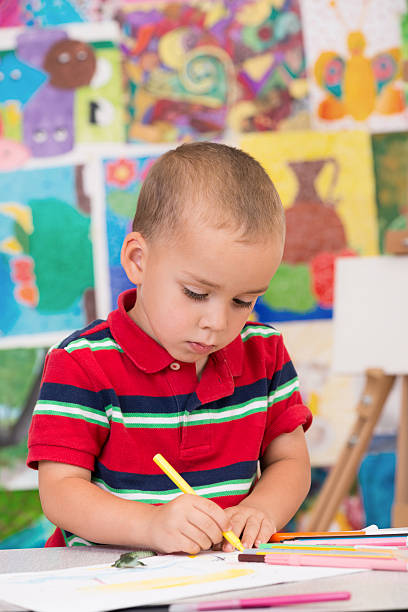 istock Cute little boy painting 500403511