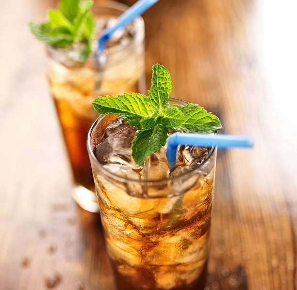 istock iced tea with blue straw and mint garnish 500405699
