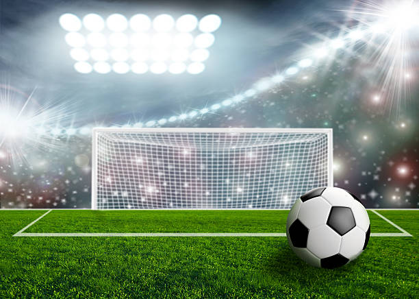 istock Soccer ball on green stadium arena 500407381