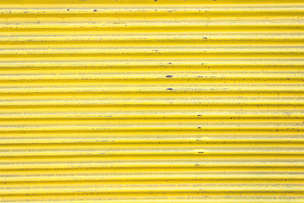 istock Yellow corrugated metal sheet slide door as background 500408303
