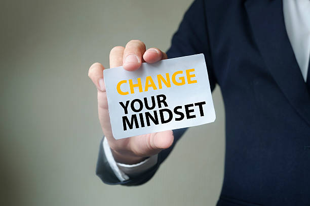 istock CHANGE YOUR MINDSET message on the card held by businessman 500420556