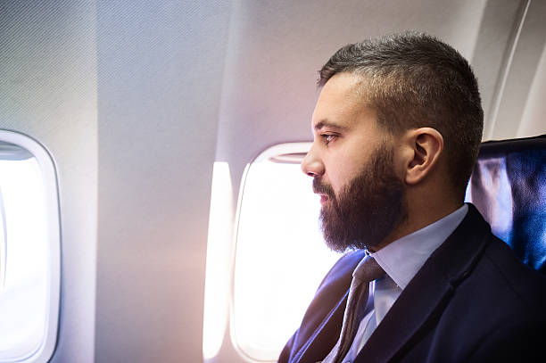 istock Businessman in airplane 500420878