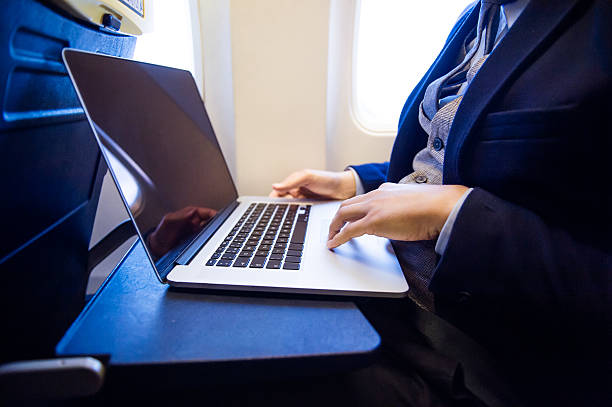 istock Businessman in airplane 500420980