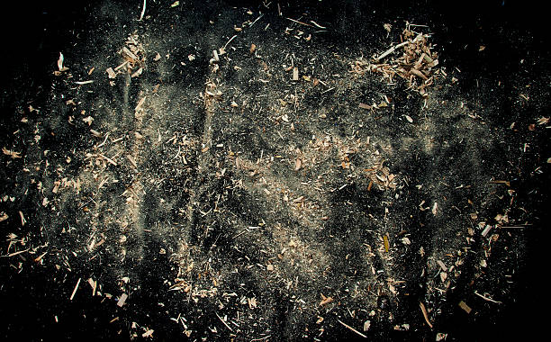 Explosion of sawdust on black background. Wood and sawdust background texture. sliver stock pictures, royalty-free photos & images