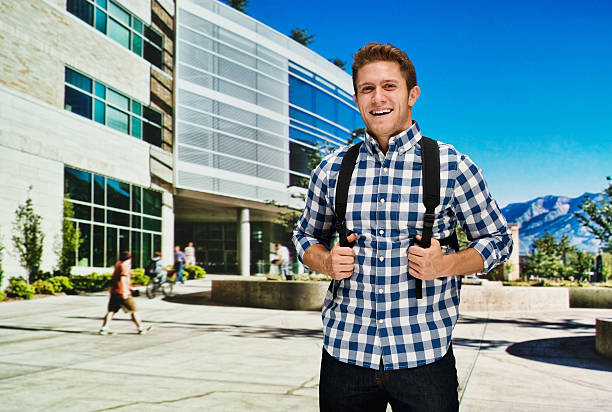Student standing at University campus Student standing at University campushttp://www.twodozendesign.info/i/1.png brigham young university stock pictures, royalty-free photos & images