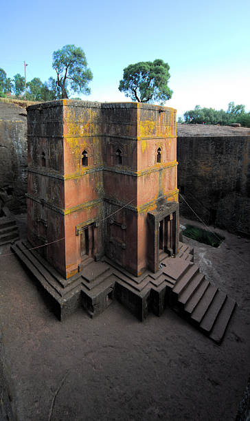 Lalibela, Ethiopia: rock-hewn Church of Saint George Lalibela, Amhara region, Ethiopia: rock-hewn Church of Saint George / Biete Giyorgis - carved from red volcanic rock in the shape of a cross - 12th century - the most famous of the eleven monolithic churches in Lalibela - Ethiopian Orthodox Tewahedo Church - UNESCO world heritage site - photo by M.Torres the church of saint george lalibela ethiopia stock pictures, royalty-free photos & images