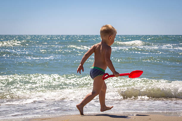 istock Cute baby boy playing with beach toys 500426432