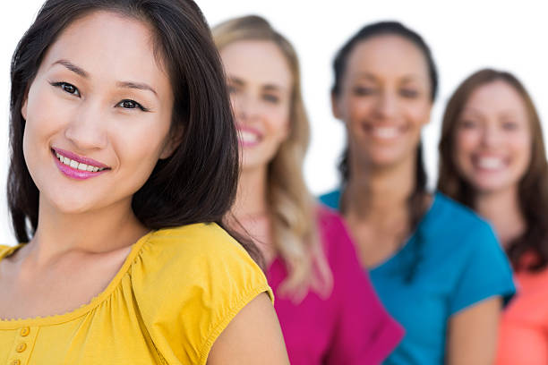 istock Smiling models in line posing with focus on asian model 500427723