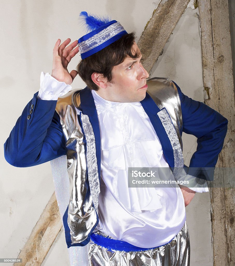 prince man dressed as a prince with a blue hat making a grimace Adult Stock Photo