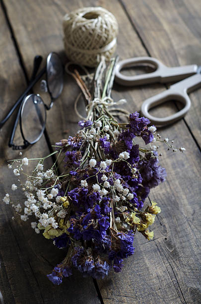 istock Dried flowers on an old table 500428796