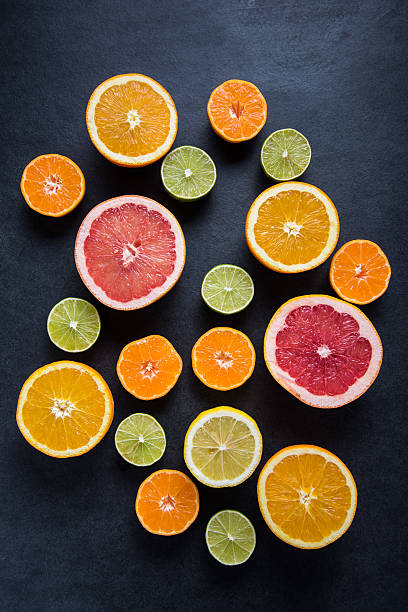 istock Citrus half cut fruits on dark background 500430284